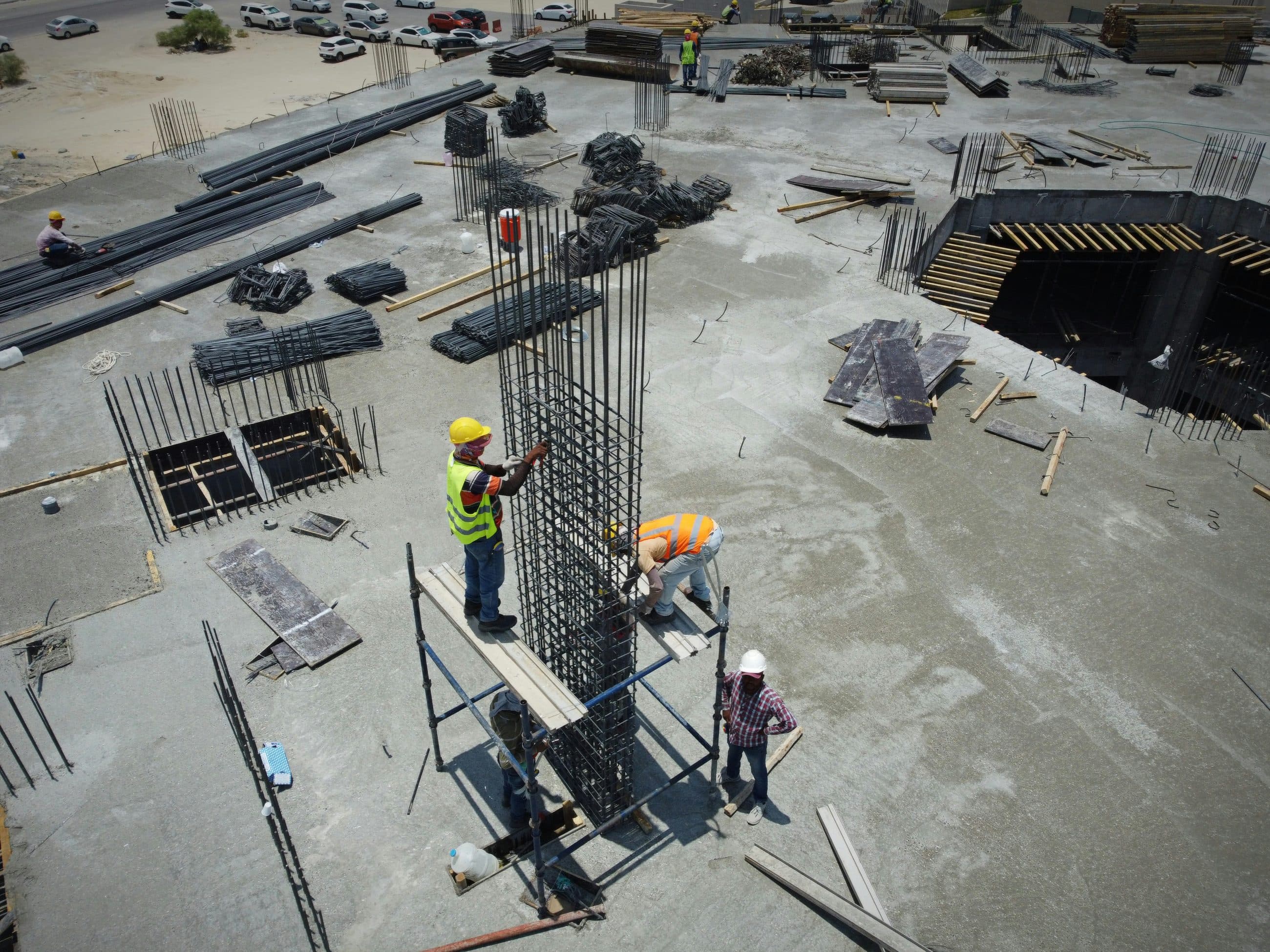 Aerial view of a building site with reinforced concrete columns under construction