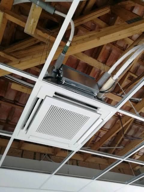 Cassette air conditioning unit and ductwork fitted to a roof structure