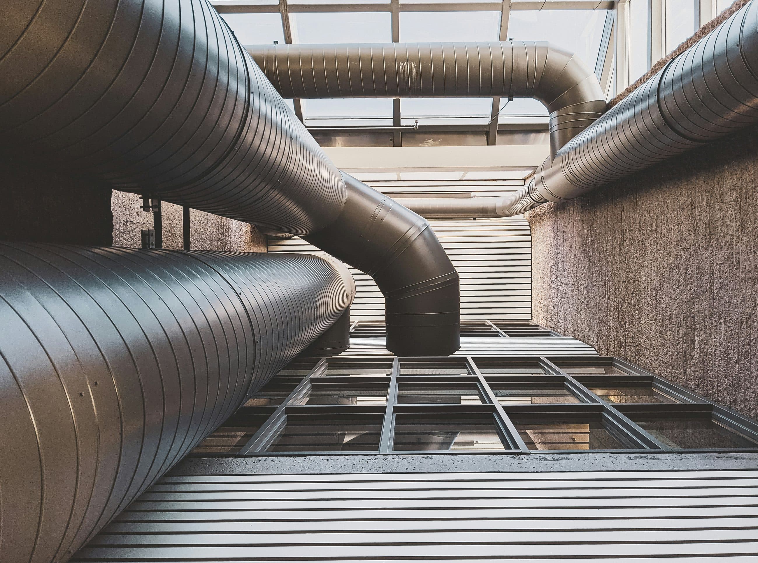 Spiral ductwork and ventilation runs installed across a building ceiling