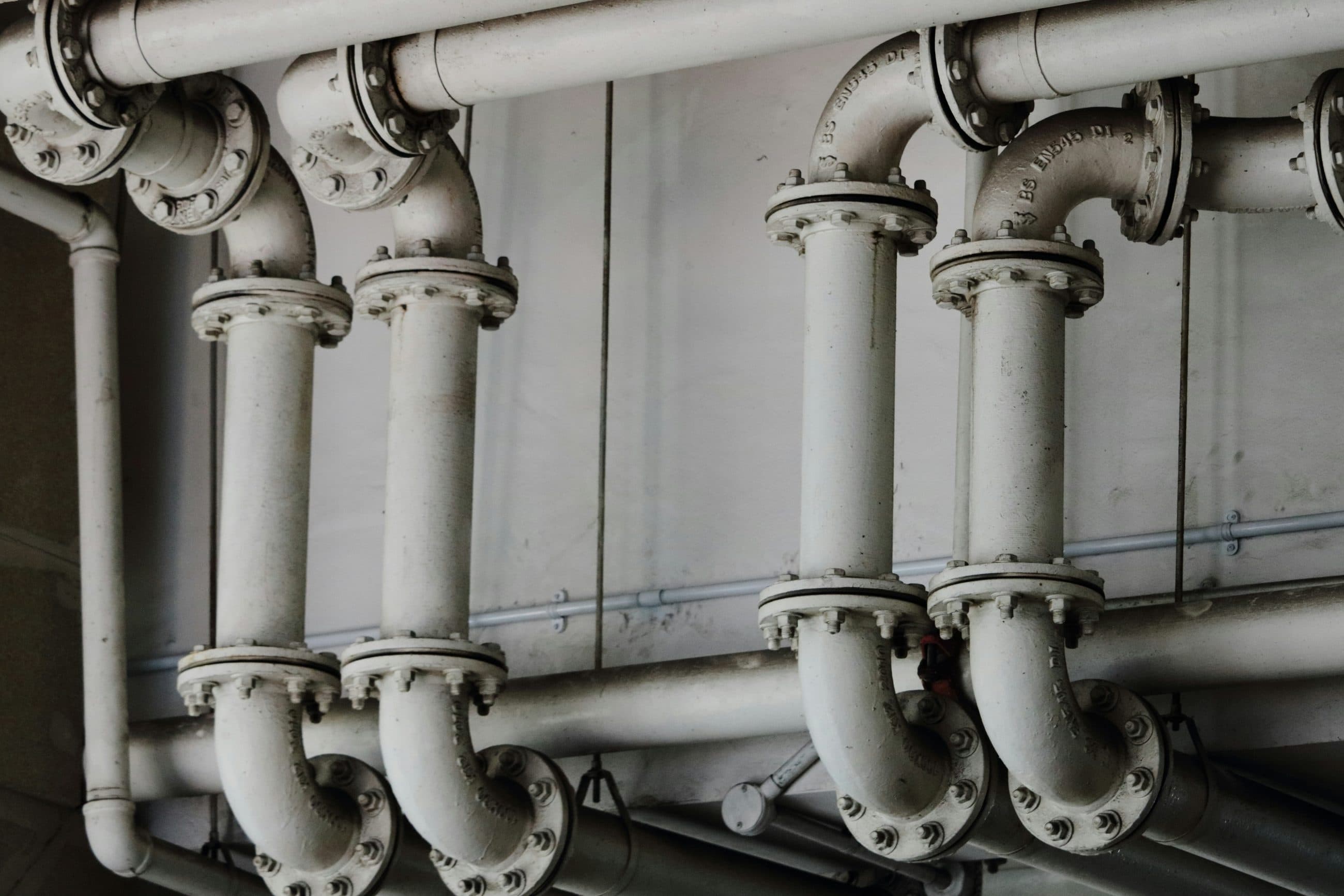 Flanged pipework manifold routed through a plant room