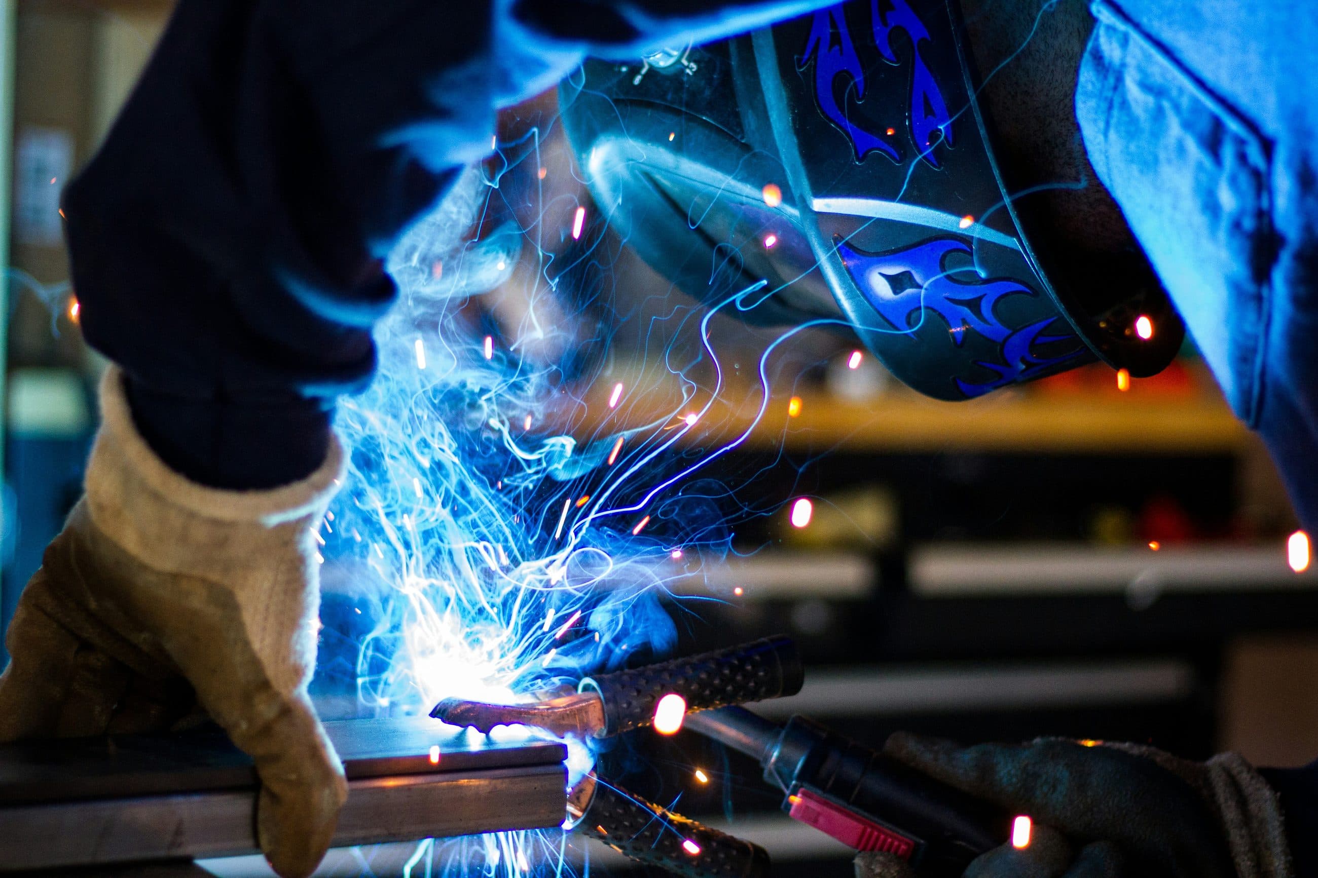 Welder joining steel sections, arc lighting the workpiece
