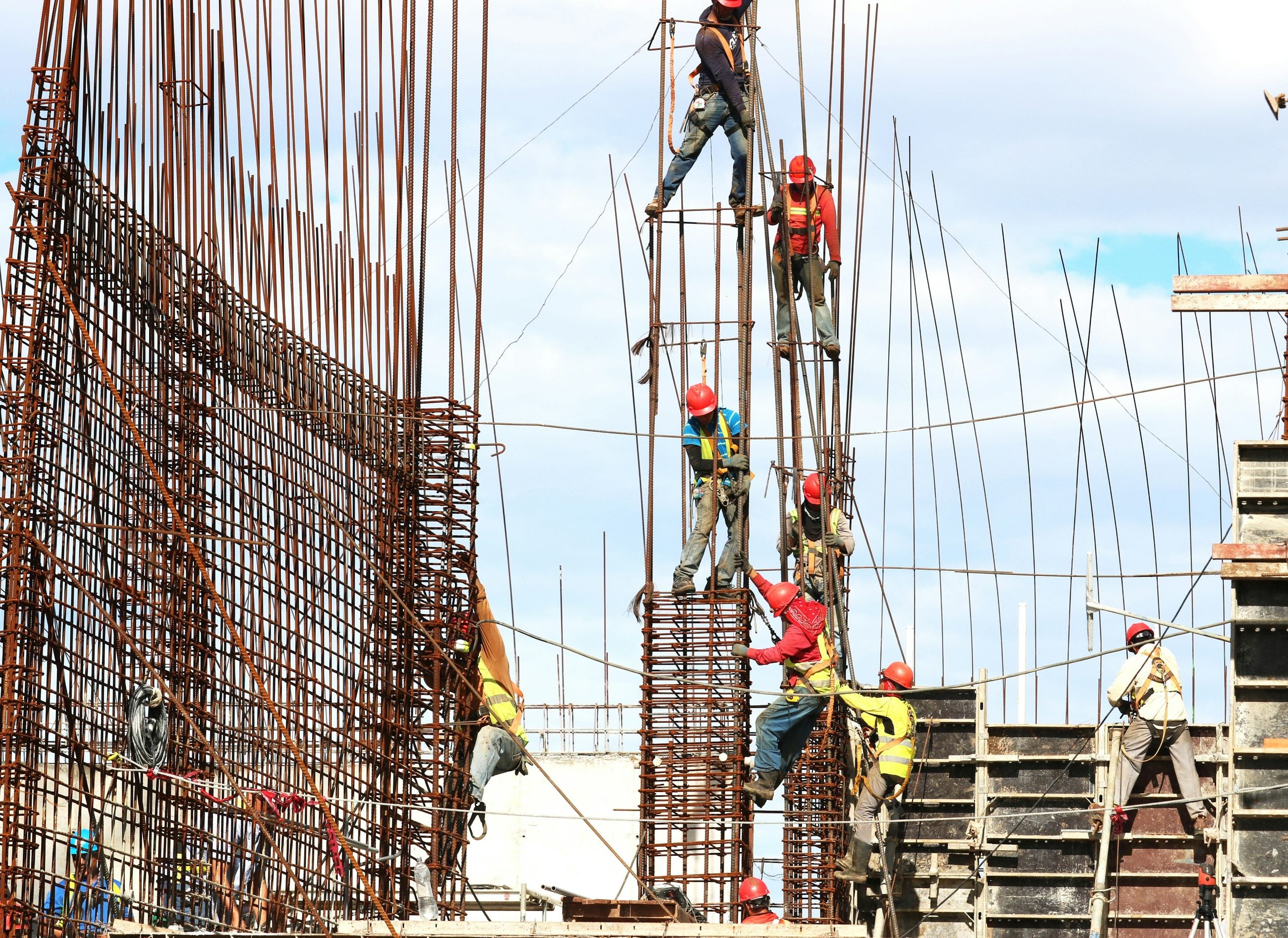Site crew working across reinforcement steel on a large structure