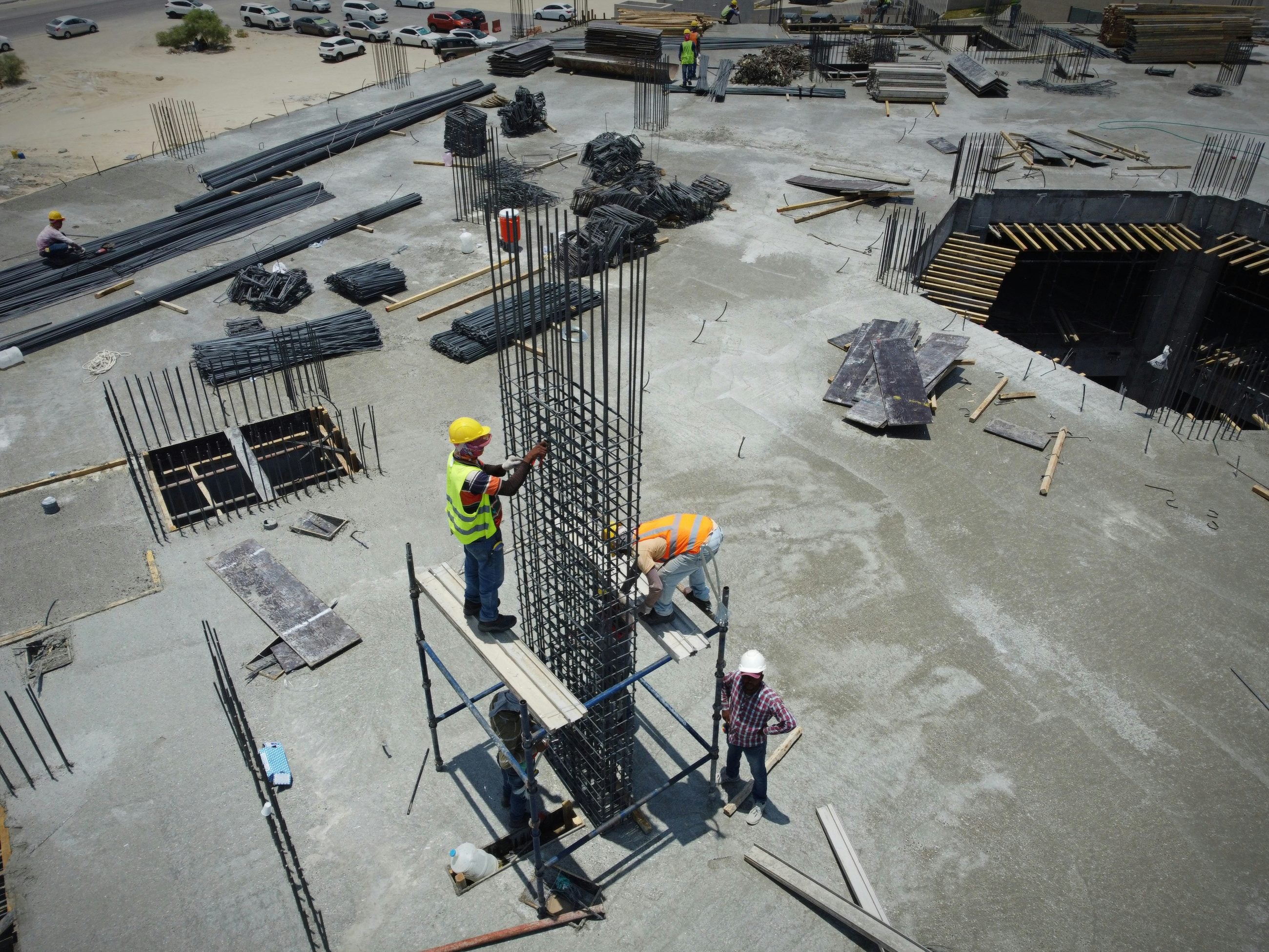 Aerial view of a building site with reinforced concrete columns under construction
