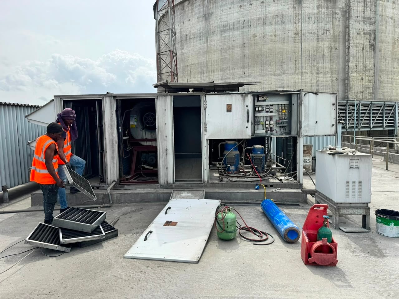 Helmont technicians servicing rooftop air handling units on an industrial site