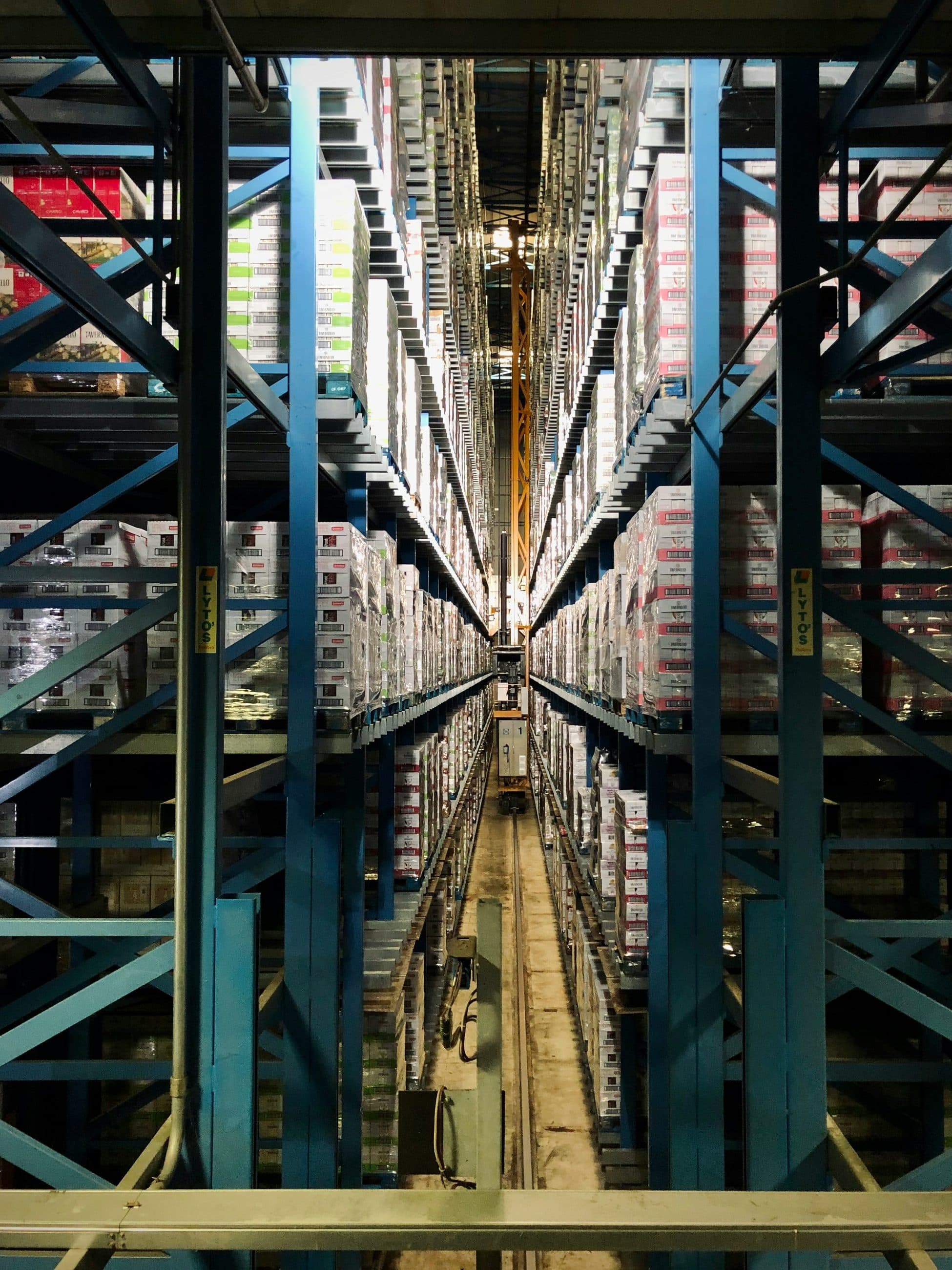 Aisle of high-bay warehouse racking holding industrial stock