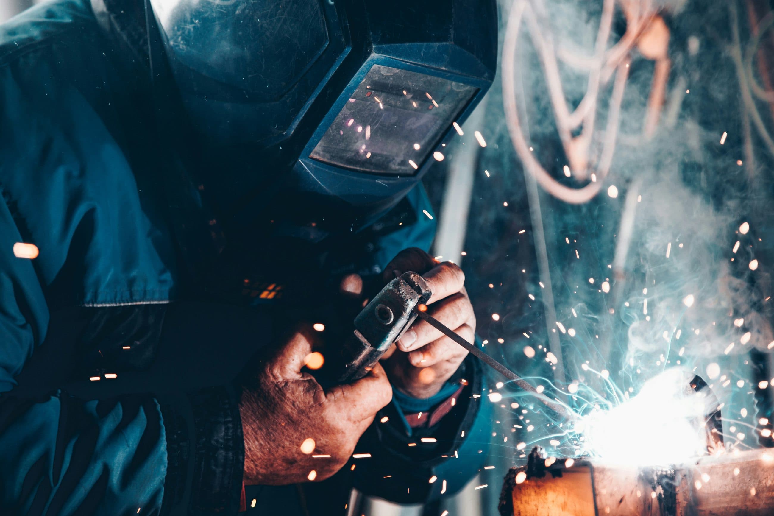 Close-up of a welded joint being completed on a steel assembly